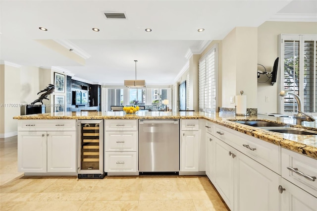 kitchen featuring crown molding, a healthy amount of sunlight, sink, and beverage cooler