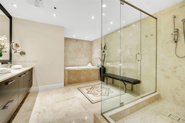 bathroom featuring shower with separate bathtub, vanity, and tile patterned floors