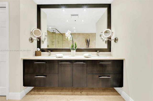 bathroom with tile patterned floors, vanity, and a shower with shower door