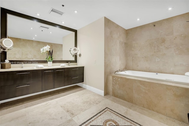 bathroom with tiled bath and vanity