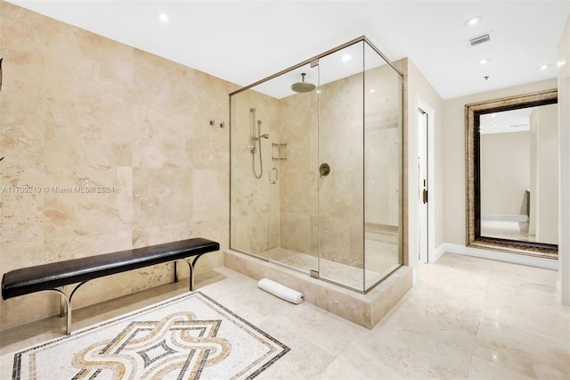 bathroom featuring tiled shower and tile walls