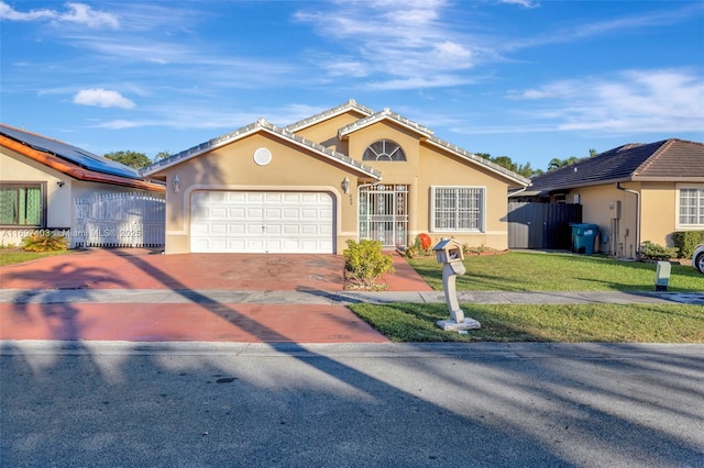 699 NW 134th Pl, Miami, FL 33182 - view of front of home featuring a garage, fence, a front lawn, and stucco siding