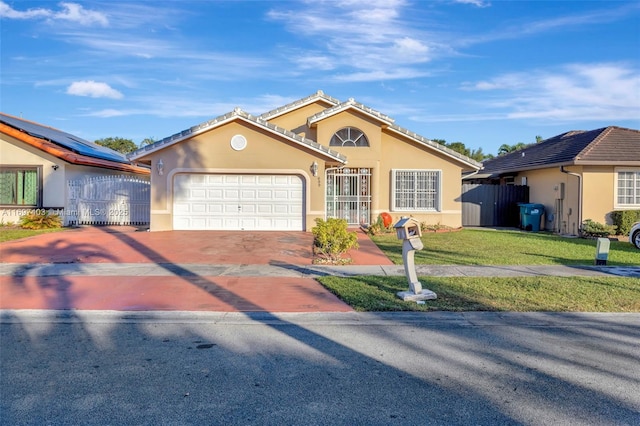 view of front of home featuring a garage, fence, a front lawn, and stucco siding