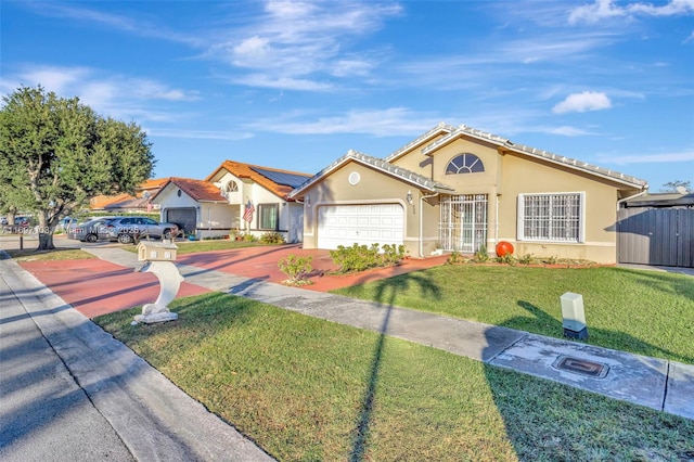 view of front facade with a garage, a tiled roof, a front lawn, and stucco siding