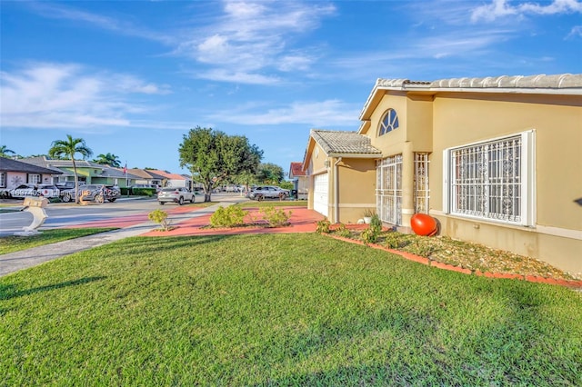 699 NW 134th Pl, Miami, FL 33182 - view of yard with an attached garage and a residential view