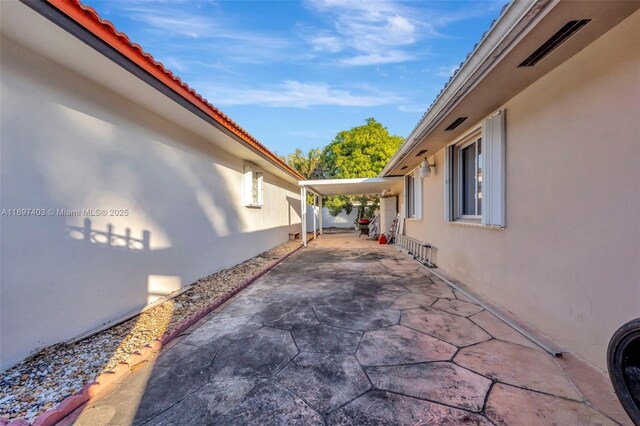 view of side of property featuring a patio