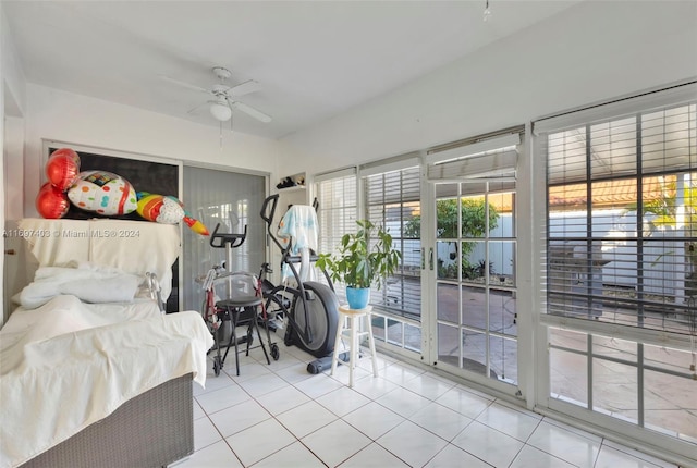 bedroom featuring access to exterior, tile patterned floors, and ceiling fan