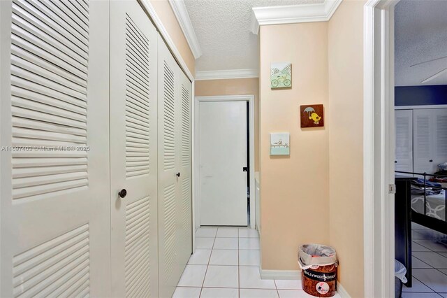 699 NW 134th Pl, Miami, FL 33182 - hallway featuring a textured ceiling, light tile patterned flooring, and crown molding