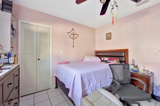 bedroom with ceiling fan, a closet, and light tile patterned flooring