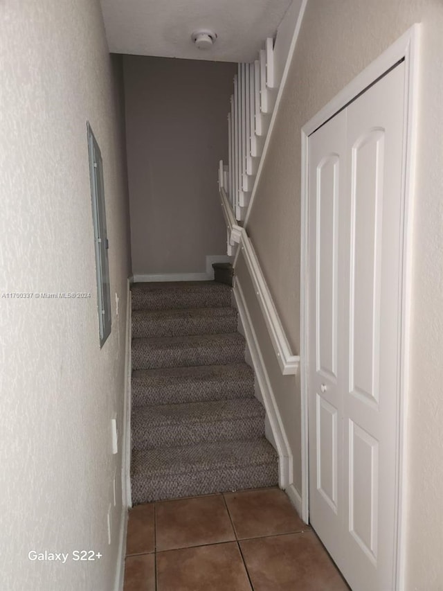 staircase featuring tile patterned floors