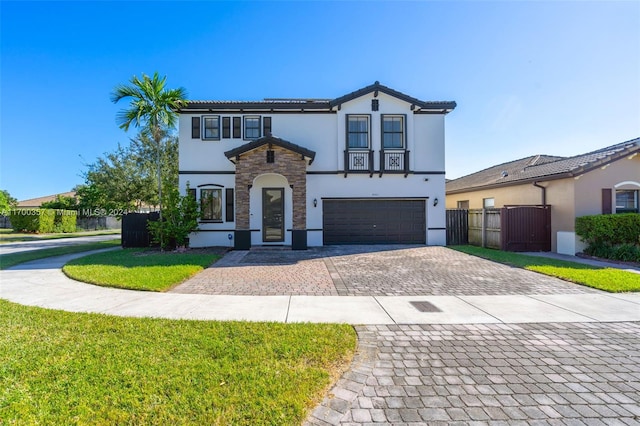 view of front of property featuring a garage and a front lawn