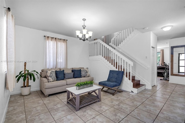 living room featuring light tile patterned floors, a wealth of natural light, and a chandelier