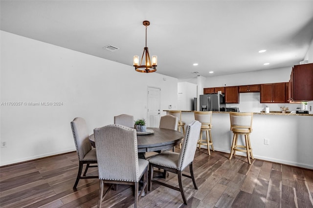 dining room with a chandelier and dark hardwood / wood-style flooring