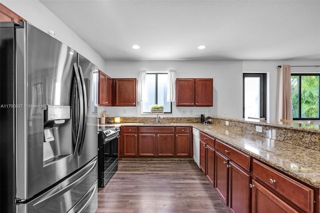 kitchen with sink, a healthy amount of sunlight, dark hardwood / wood-style floors, and appliances with stainless steel finishes