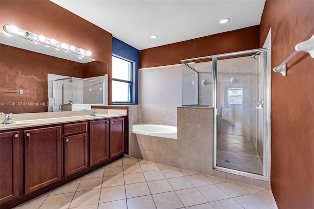 bathroom with tile patterned flooring, vanity, and separate shower and tub