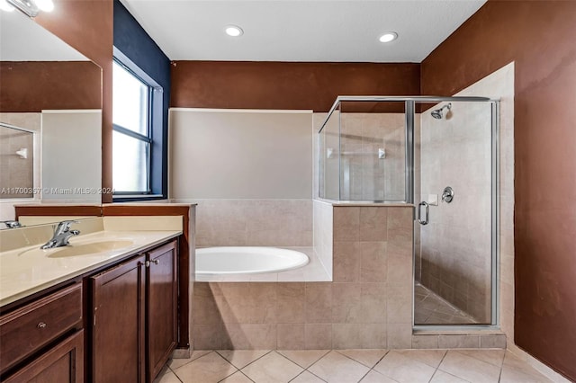 bathroom featuring tile patterned floors, vanity, and separate shower and tub