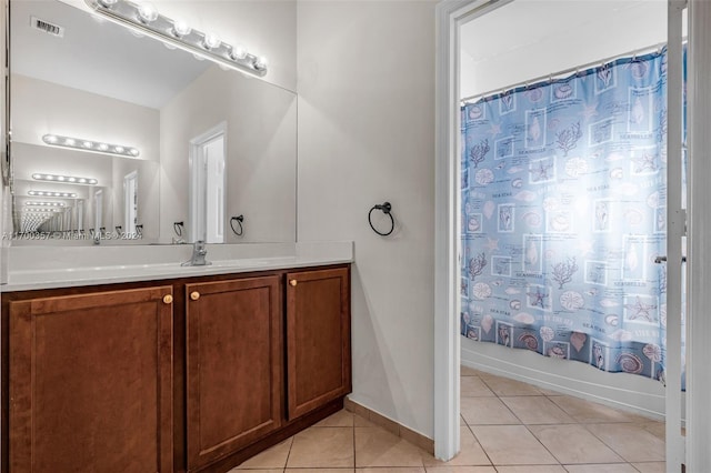 bathroom featuring tile patterned flooring, vanity, and shower / bathtub combination with curtain