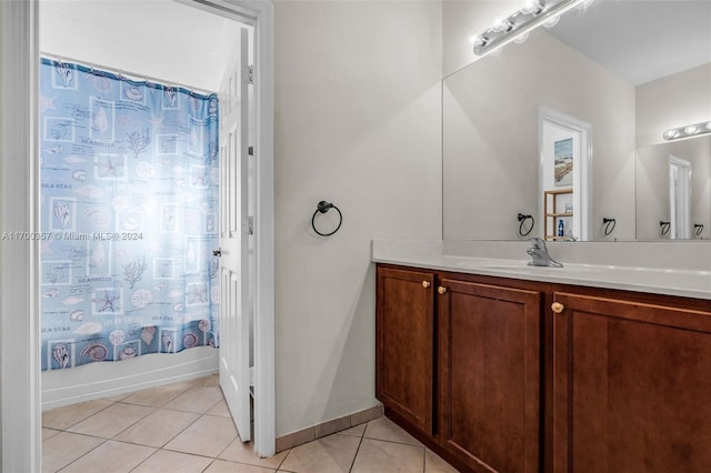 bathroom with tile patterned flooring, vanity, and shower / tub combo