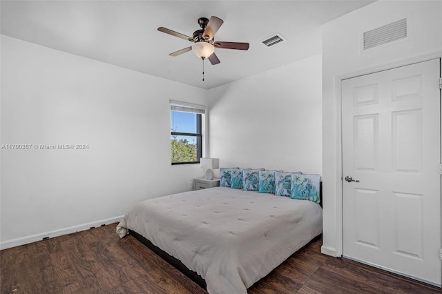 bedroom with ceiling fan and dark wood-type flooring