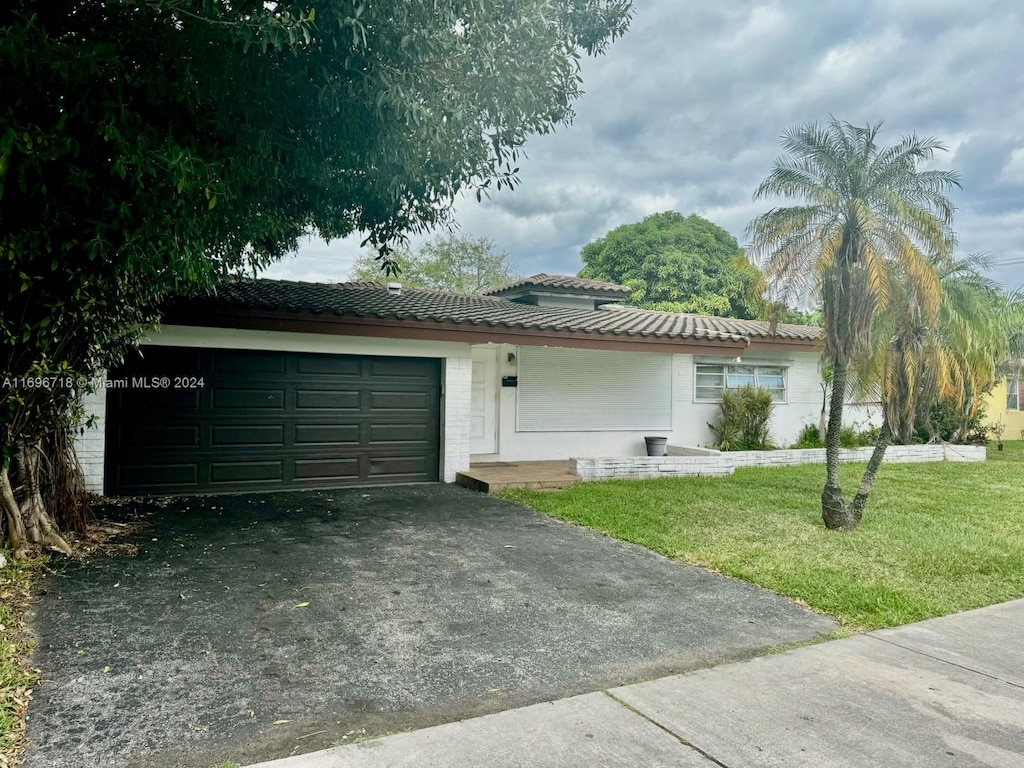 view of home's exterior featuring a yard and a garage