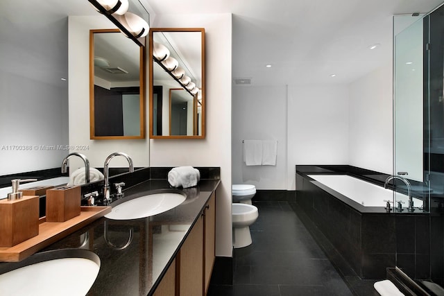 bathroom with vanity, a bidet, tile patterned flooring, tiled bath, and toilet