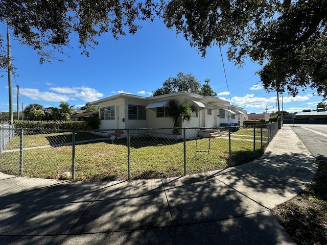 view of side of home with a yard