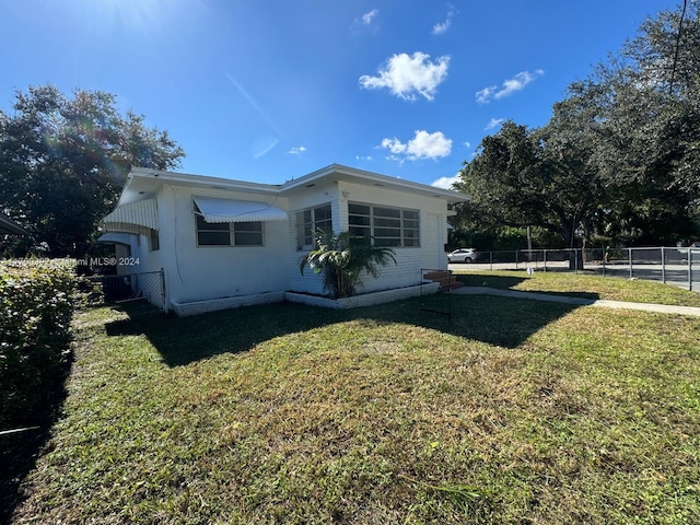 view of home's exterior with a lawn