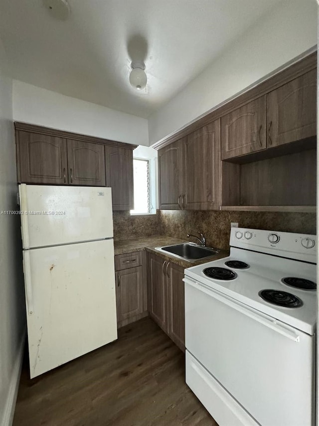 kitchen with decorative backsplash, sink, dark wood-type flooring, and white appliances