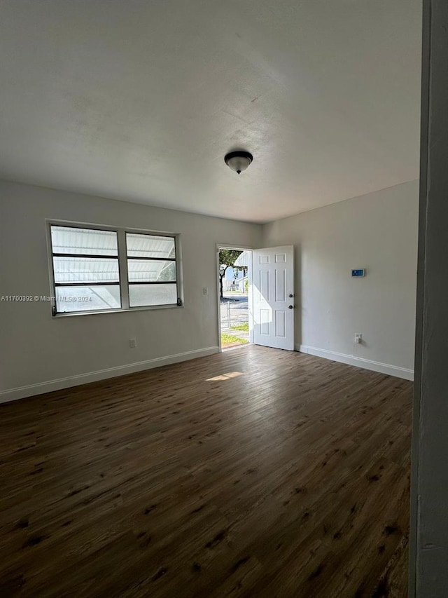 spare room with dark hardwood / wood-style flooring