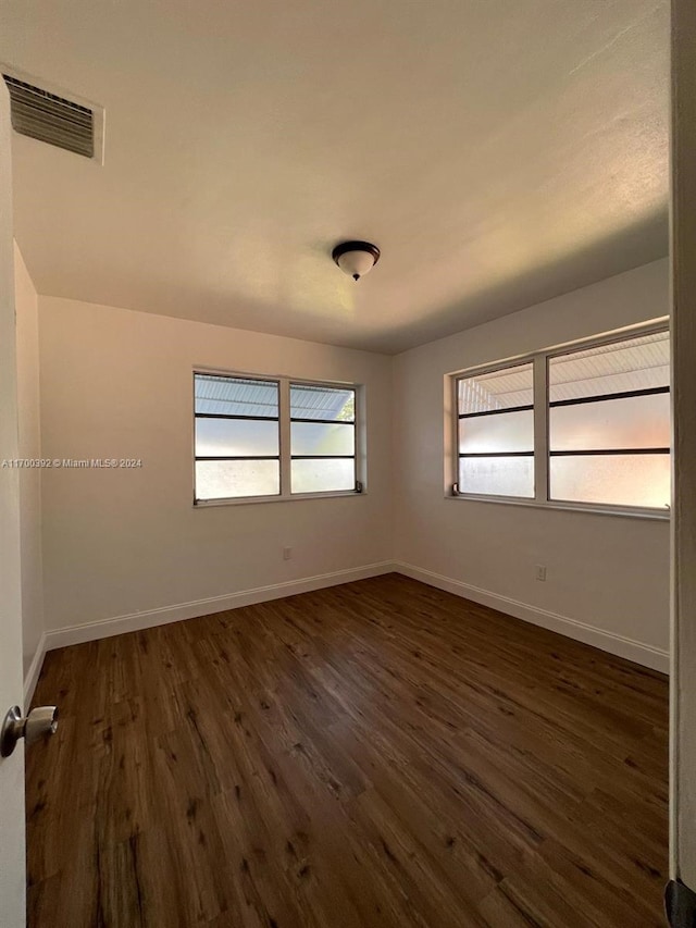 empty room featuring dark wood-type flooring