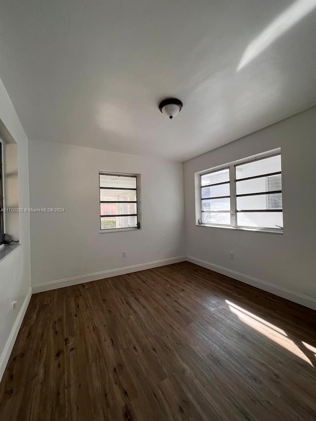 unfurnished room featuring dark hardwood / wood-style floors