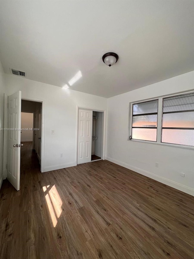 unfurnished bedroom featuring dark hardwood / wood-style flooring