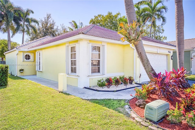 view of home's exterior with a yard and a garage