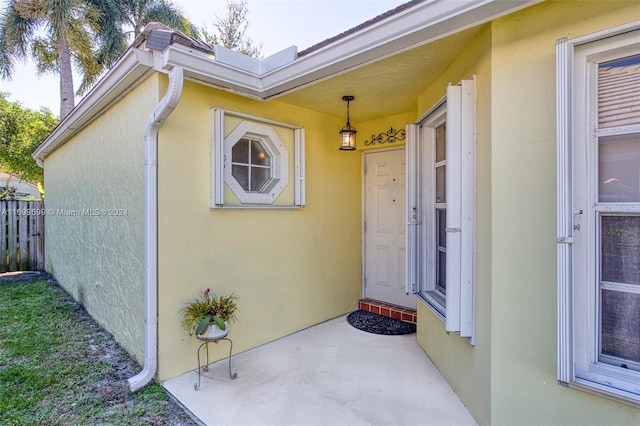 view of exterior entry featuring a patio