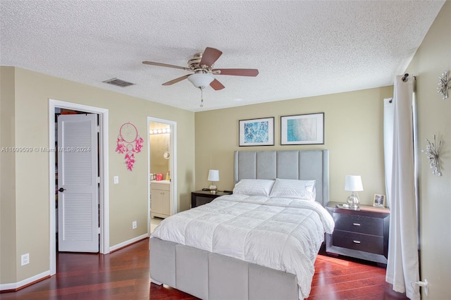 bedroom featuring ensuite bathroom, ceiling fan, a textured ceiling, dark hardwood / wood-style flooring, and a closet