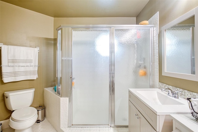 bathroom with tile patterned floors, vanity, toilet, and a shower with shower door