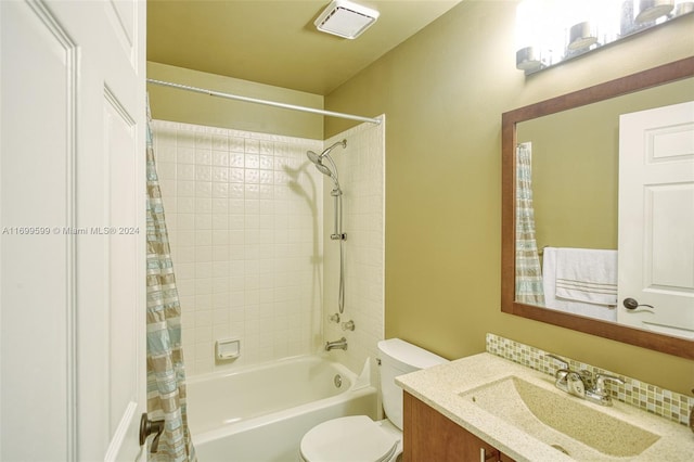 full bathroom with vanity, shower / bath combo, and toilet