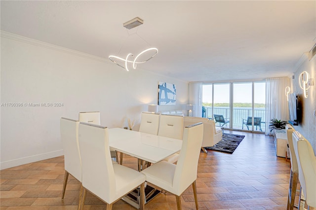 dining space with floor to ceiling windows and crown molding