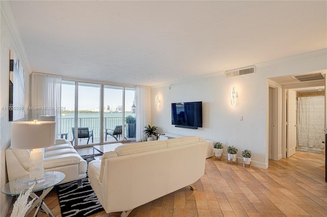 living room featuring floor to ceiling windows, light hardwood / wood-style flooring, and ornamental molding