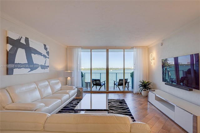 living room featuring light hardwood / wood-style flooring, a wall of windows, and ornamental molding