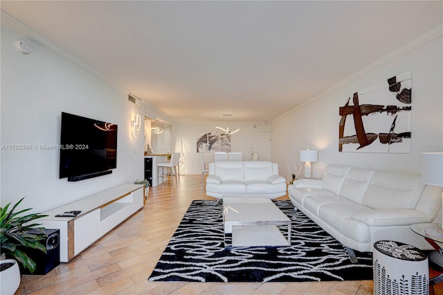 living room featuring light hardwood / wood-style floors and ornamental molding