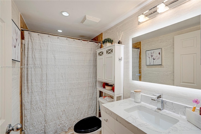 bathroom featuring vanity, toilet, and walk in shower