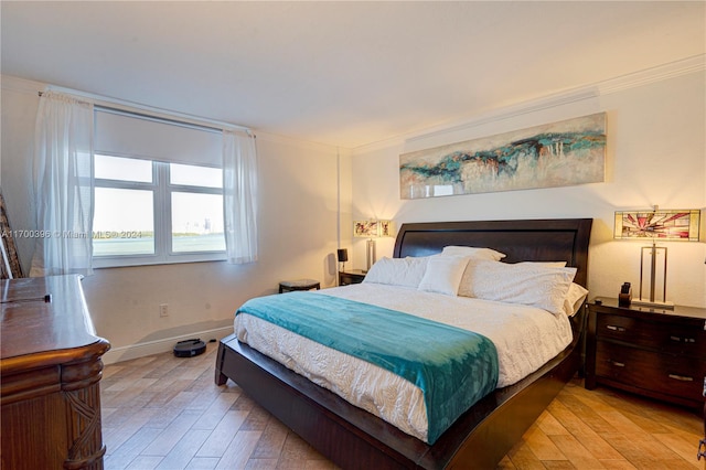 bedroom featuring crown molding and light wood-type flooring