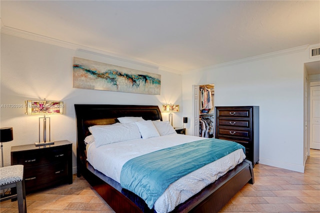 bedroom with a walk in closet, a closet, and ornamental molding