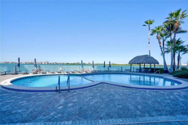 view of swimming pool with a gazebo, a patio, and a water view