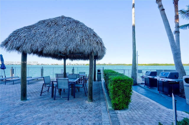 view of patio featuring a gazebo and a water view