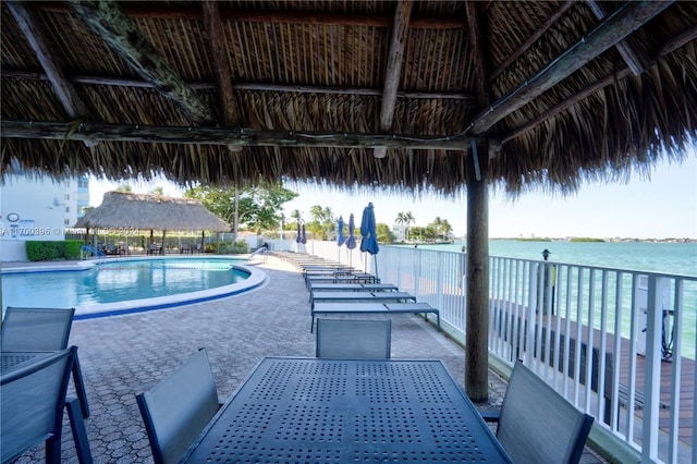 view of swimming pool with a gazebo, a water view, and a patio