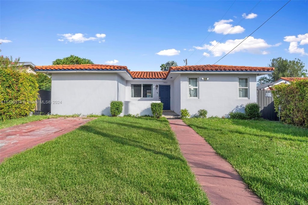 mediterranean / spanish-style house with a front yard