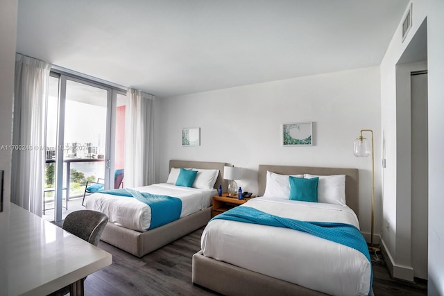 bedroom featuring dark hardwood / wood-style flooring and access to outside