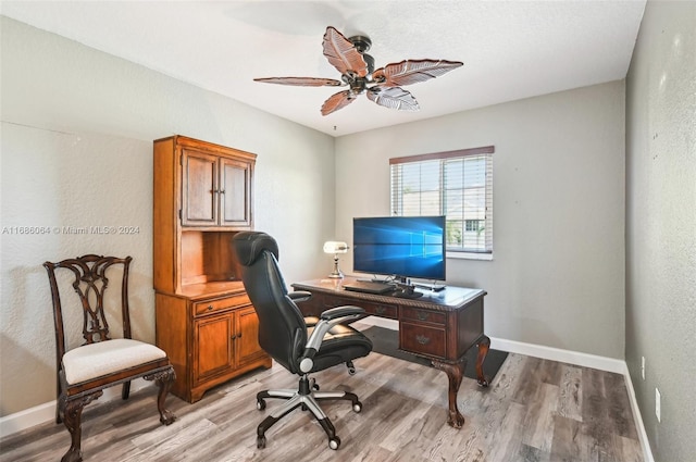 office with light hardwood / wood-style flooring and ceiling fan